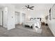 Bright main bedroom boasts a ceiling fan, carpet, and a feature wall behind the bed at 4933 S Xenon Ct, Morrison, CO 80465