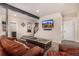 Finished basement with leather furniture, a TV, and easy access to the staircase at 11857 S Saunter Ln, Parker, CO 80138