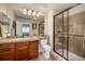 Bathroom features a glass shower, a large vanity, and natural-colored tiling at 11857 S Saunter Ln, Parker, CO 80138