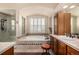 Bathroom featuring a soaking tub, walk-in shower, and vanity at 11857 S Saunter Ln, Parker, CO 80138