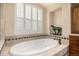 Spa-like bathroom featuring a soaking tub and decorative accents at 11857 S Saunter Ln, Parker, CO 80138