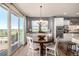 Eat-in kitchen dining area features a large round table, great light, and easy access to the outdoor deck at 11857 S Saunter Ln, Parker, CO 80138