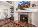 Cozy living room fireplace with stone surround, custom mantle and millwork, and hardwood flooring at 11857 S Saunter Ln, Parker, CO 80138