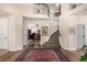 Welcoming foyer with a curved staircase, hardwood floors, and a view into an adjacent office space at 11857 S Saunter Ln, Parker, CO 80138