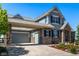 Beautiful home featuring a covered parking area, stone accents, and well-maintained landscaping leading to the front entrance at 11857 S Saunter Ln, Parker, CO 80138