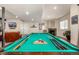 Basement game room features a pool table, a fireplace, and a comfortable seating area at 11857 S Saunter Ln, Parker, CO 80138