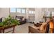 Open hallway with comfortable seating, natural light, and a staircase with wrought iron railings at 11857 S Saunter Ln, Parker, CO 80138