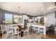 Bright, open kitchen with white cabinets, stainless steel appliances, granite counters, and a cozy breakfast nook at 11857 S Saunter Ln, Parker, CO 80138