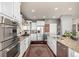 Modern kitchen with stainless steel appliances, granite countertops, tile backsplash, and custom cabinets at 11857 S Saunter Ln, Parker, CO 80138