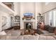 Inviting living room features a stone fireplace, soaring ceilings, and large windows for lots of natural light at 11857 S Saunter Ln, Parker, CO 80138