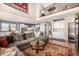Spacious living room flows into the kitchen, with hardwood floors and soaring ceilings for seamless entertaining at 11857 S Saunter Ln, Parker, CO 80138