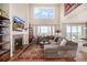 Bright, open living room with high ceilings, fireplace, and large windows with scenic views of the neighborhood at 11857 S Saunter Ln, Parker, CO 80138