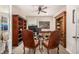 Home office featuring custom wood built-in shelving, neutral colors, and a comfortable seating arrangement at 11857 S Saunter Ln, Parker, CO 80138
