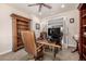 Well-appointed office space featuring a large wooden desk, bookshelves, and plenty of natural light at 11857 S Saunter Ln, Parker, CO 80138