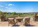 A stone patio features a cozy outdoor fire pit and comfortable seating at 11857 S Saunter Ln, Parker, CO 80138