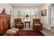 Cozy sitting area with two leather chairs, a small table, and an antique cabinet, creating a comfortable retreat at 11857 S Saunter Ln, Parker, CO 80138