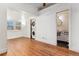 Large bedroom with hardwood floors, a stacked washer/dryer and an ensuite bathroom at 1748 S Logan St, Denver, CO 80210