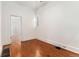 Bedroom featuring hardwood floors, white walls and trim, and white doors at 1748 S Logan St, Denver, CO 80210