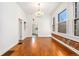 Bright dining room featuring hardwood floors, a chandelier, and exposed brick at 1748 S Logan St, Denver, CO 80210