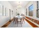 Staged dining room featuring hardwood floors, a chandelier, and exposed brick at 1748 S Logan St, Denver, CO 80210