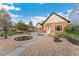 Attractive brick home with inviting walkway, rock garden, mature landscaping, and detached garage at 1748 S Logan St, Denver, CO 80210