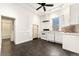 Bright kitchen features white cabinets, appliances, and a dark floor, plus a window for natural light at 1748 S Logan St, Denver, CO 80210