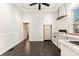 Traditional kitchen with white appliances, cabinets, and a view to a bathroom, providing essential amenities at 1748 S Logan St, Denver, CO 80210
