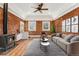 Nicely staged living room boasts exposed brick, wood floors, and decor for a modern living experience at 1748 S Logan St, Denver, CO 80210