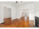 Spacious living room with hardwood floors, fireplace, and archways leading to other rooms at 1748 S Logan St, Denver, CO 80210
