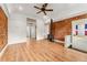 Open living room with exposed brick accent wall, wood-burning stove, and modern flooring at 1748 S Logan St, Denver, CO 80210