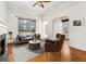 Cozy living room with modern furnishings, hardwood floors, natural light, and classic fireplace at 1748 S Logan St, Denver, CO 80210