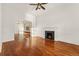Spacious living room with hardwood floors, classic fireplace, and bright natural light at 1748 S Logan St, Denver, CO 80210