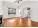 Bright living room with hardwood floors, fireplace, large window, and classic architectural details at 1748 S Logan St, Denver, CO 80210