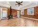 Bright living area showcasing brick walls, wood floors, and an easy transition to the kitchen at 1748 S Logan St, Denver, CO 80210