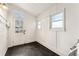 The mud room features a vintage door with glass, windows, and dark vinyl flooring at 1748 S Logan St, Denver, CO 80210