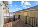 Backyard deck with black metal railing overlooking the patio at 15612 E 96Th Way # 20H, Commerce City, CO 80022