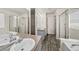 Bathroom featuring a tub and glass-walled showers at 15612 E 96Th Way # 20H, Commerce City, CO 80022