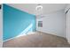 Bedroom features carpeted floor, window, ceiling fan, and blue accent wall at 15612 E 96Th Way # 20H, Commerce City, CO 80022