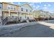 Street view of two-story townhome with a cozy front porch, landscaping, and adjacent unit at 15612 E 96Th Way # 20H, Commerce City, CO 80022