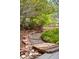 Landscaped backyard featuring a stone pathway and lush greenery at 25362 E Indore Dr, Aurora, CO 80016