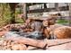 Backyard water feature with a rock waterfall and stone surround at 25362 E Indore Dr, Aurora, CO 80016