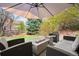 Backyard patio featuring a fire pit, comfortable seating, and manicured lawn at 25362 E Indore Dr, Aurora, CO 80016