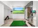 Finished basement room with a golf simulator and golf gear at 25362 E Indore Dr, Aurora, CO 80016