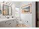 Bright bathroom featuring a modern vanity, toilet, and framed picture on the wall at 25362 E Indore Dr, Aurora, CO 80016
