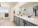 A dual sink bathroom with modern gray cabinets and countertop space at 25362 E Indore Dr, Aurora, CO 80016