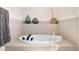 Luxurious bathroom featuring a large soaking tub and neutral tiling at 25362 E Indore Dr, Aurora, CO 80016