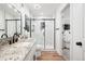 Bright bathroom with marble shower, granite countertop, and modern fixtures at 25362 E Indore Dr, Aurora, CO 80016