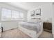Bright bedroom with a daybed, neutral colors, and natural light from the window at 25362 E Indore Dr, Aurora, CO 80016