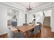 Stylish dining room with hardwood floors, views to kitchen and living areas, and elegant furniture at 25362 E Indore Dr, Aurora, CO 80016