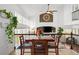 Dining area with wood table, vaulted ceilings, large windows, and an open view to the living room at 25362 E Indore Dr, Aurora, CO 80016